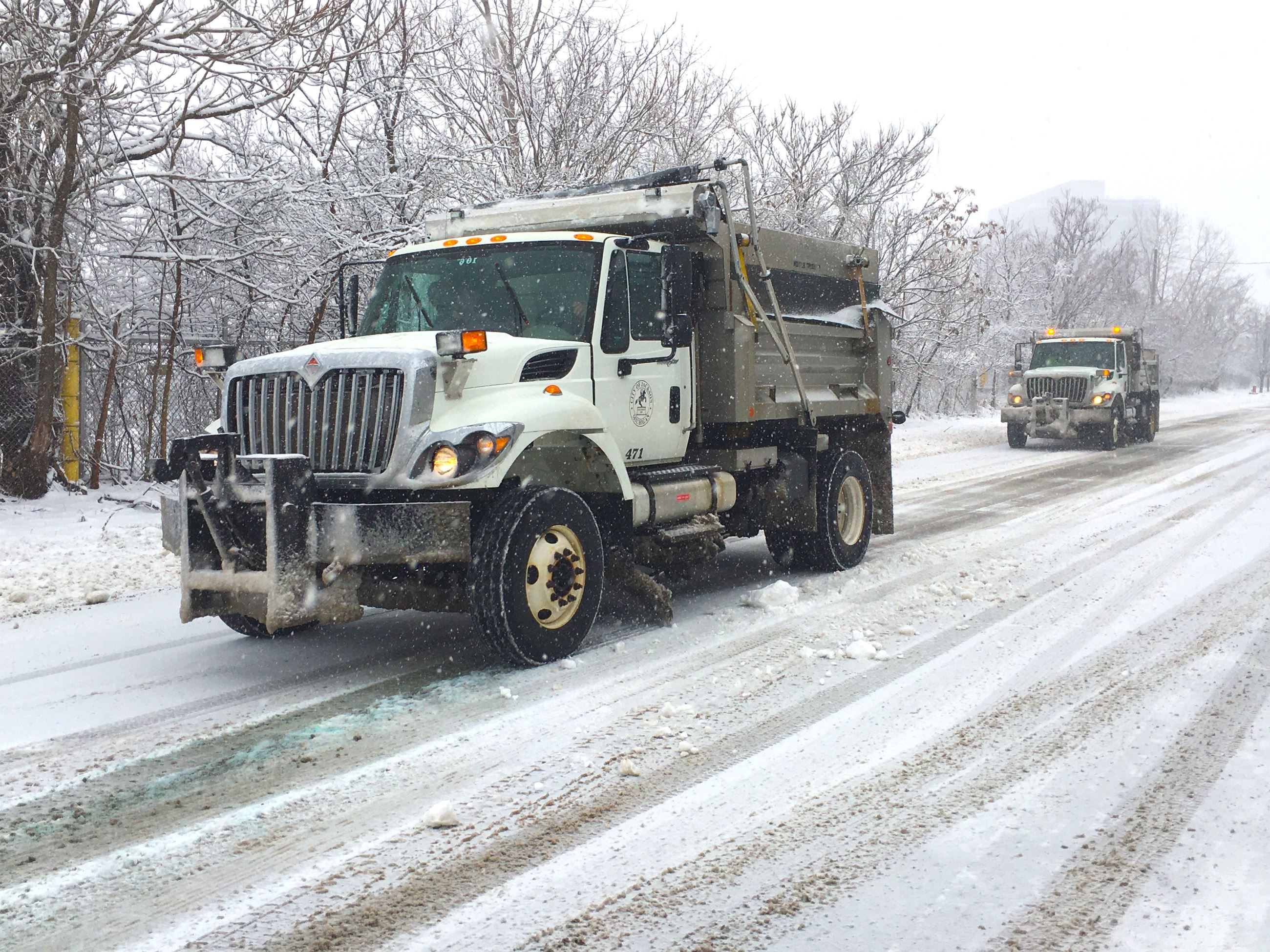 Salta and plow trucks on a snowy road in jackson 