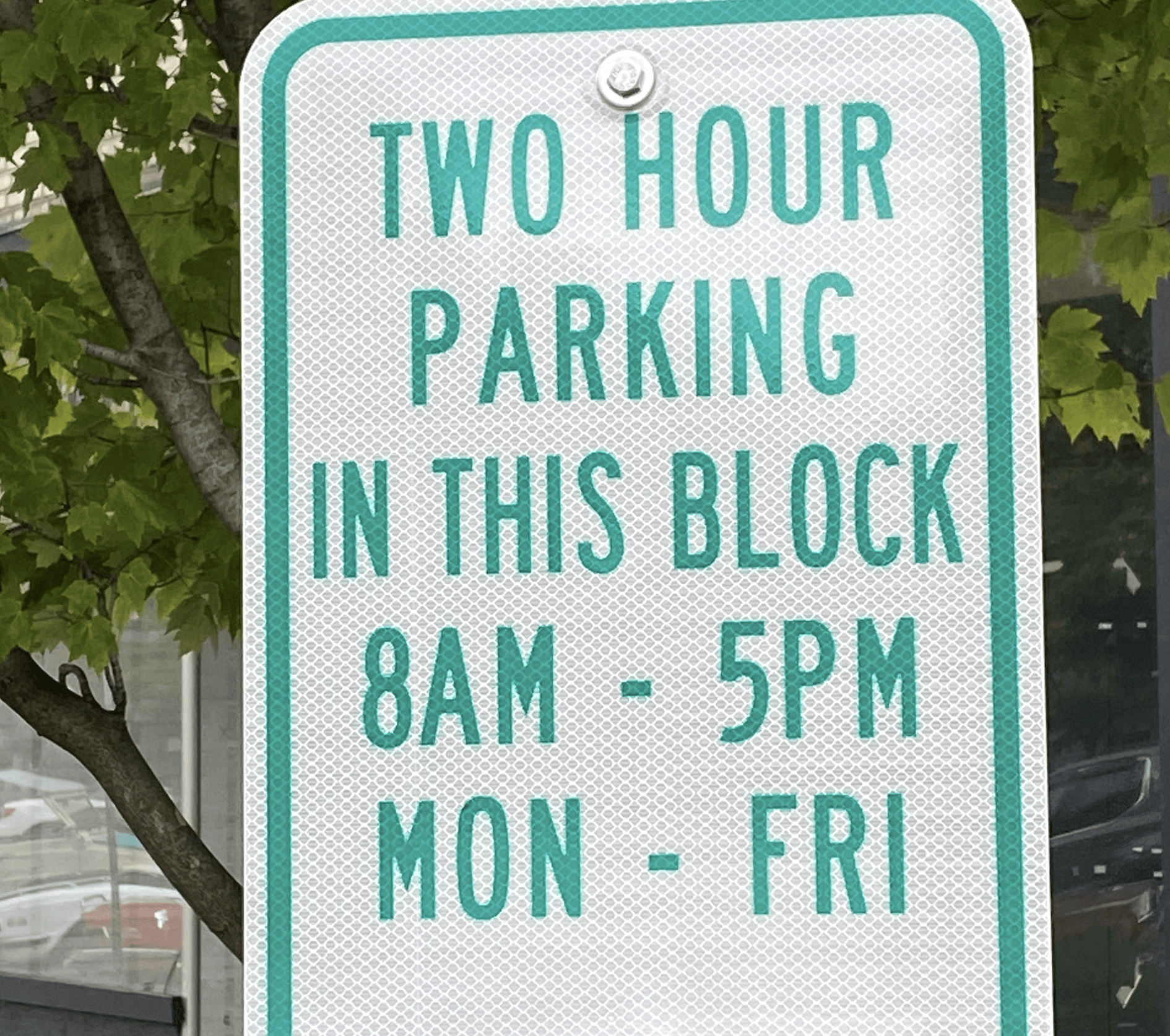 A sign about 2 hour parking with times and days