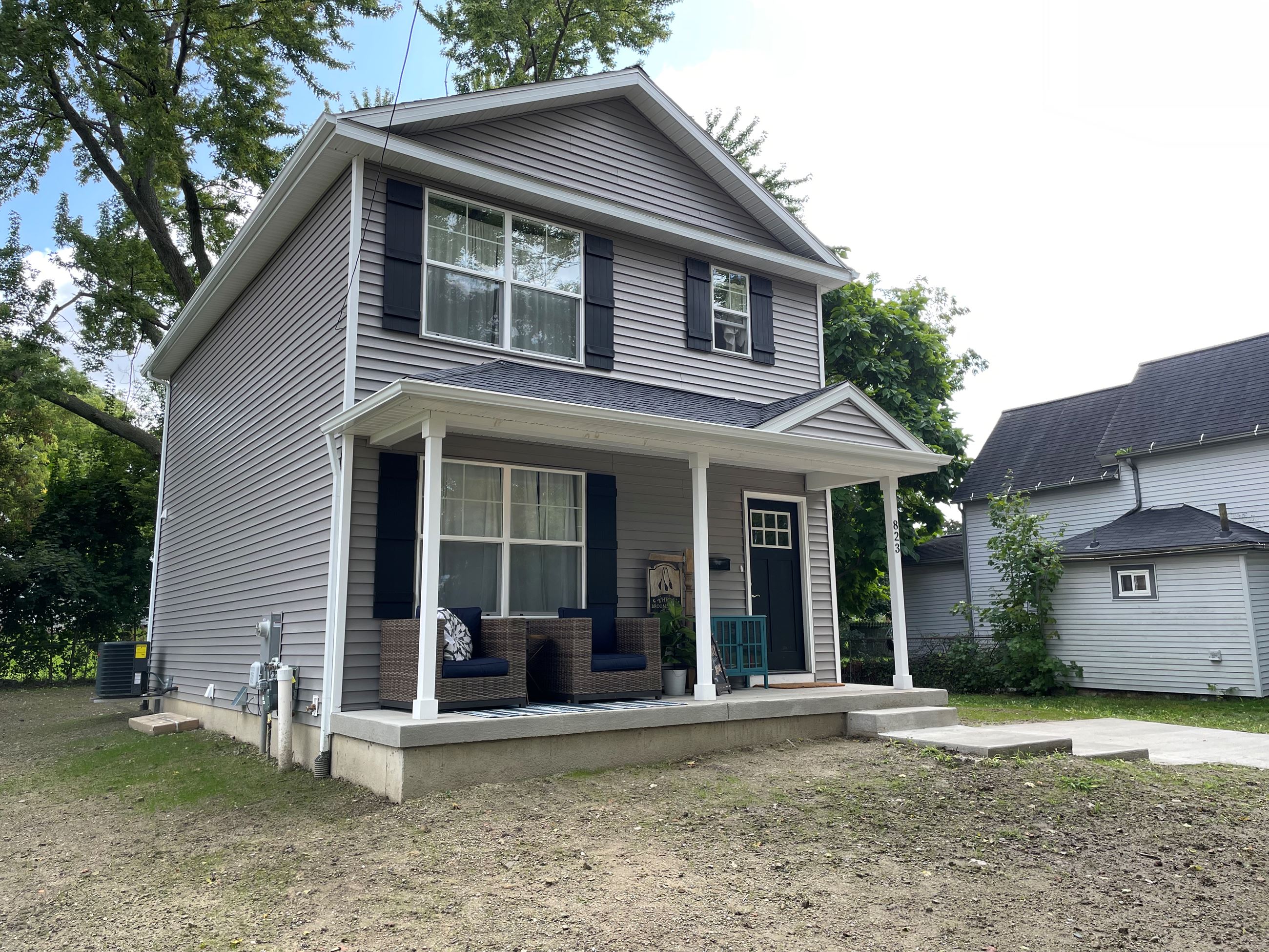 A 2 story gray house is complete 