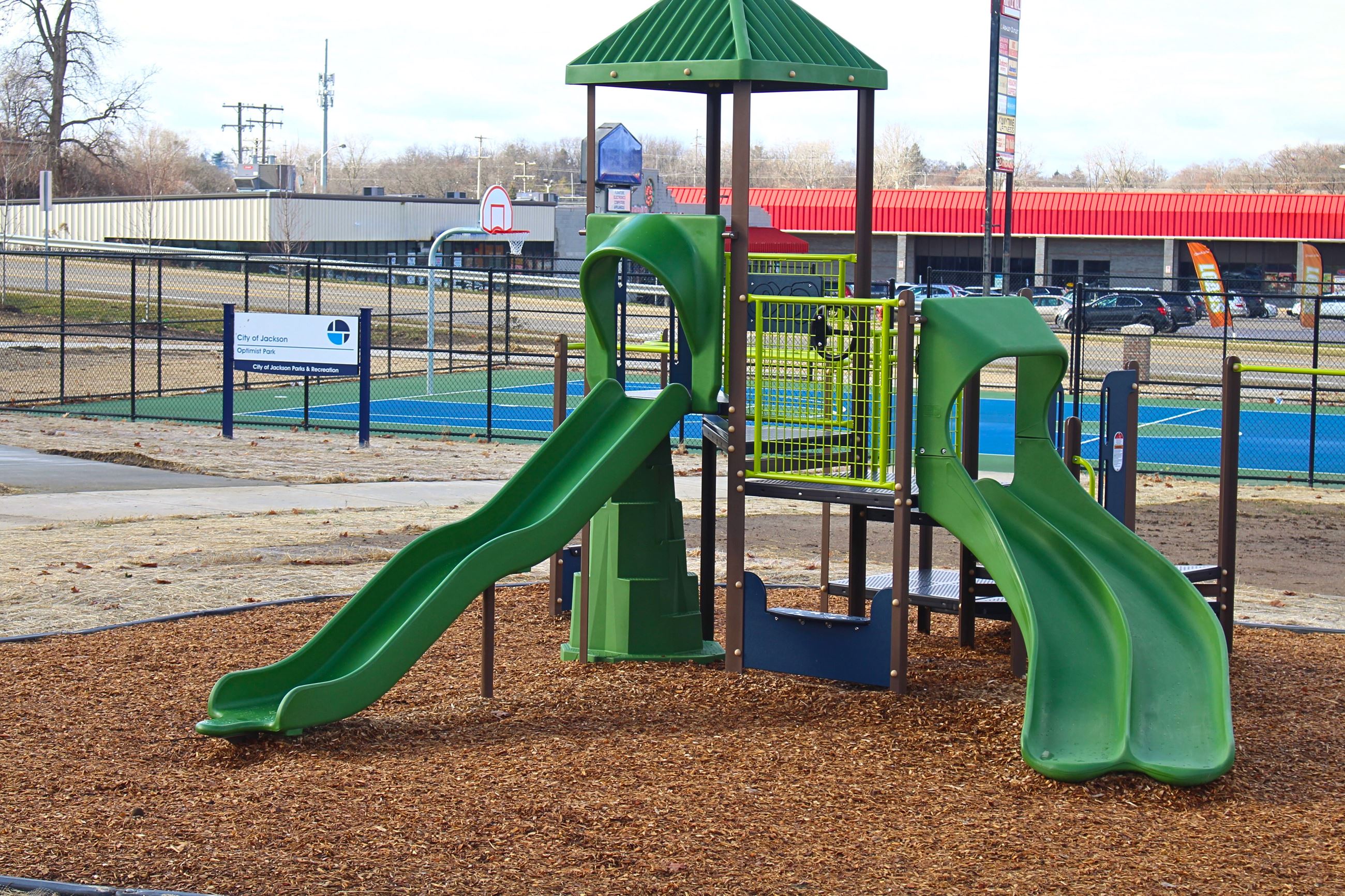Photo of a playground and basketball court 