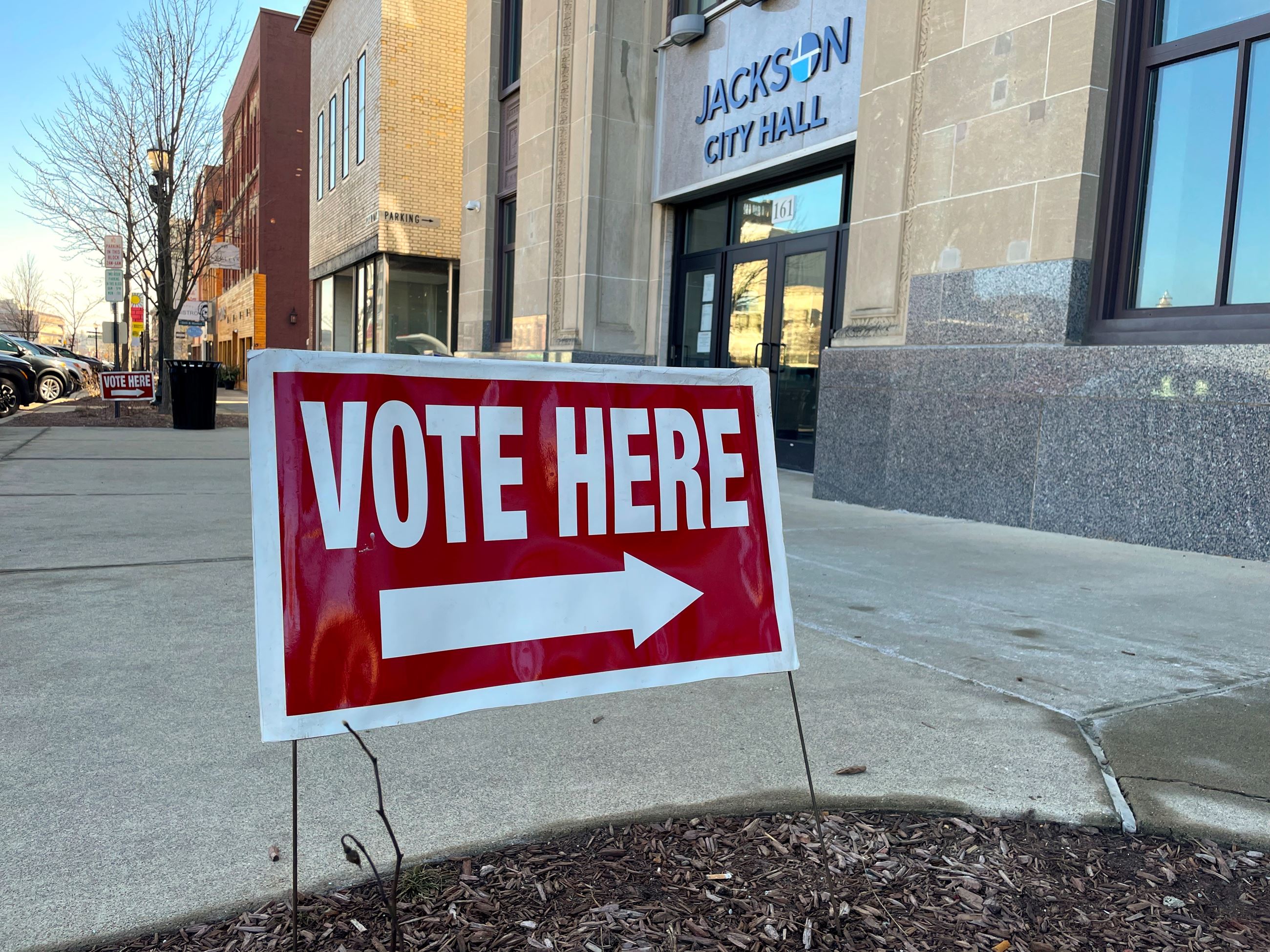 A vote here sign in front of a building that says City Hall 