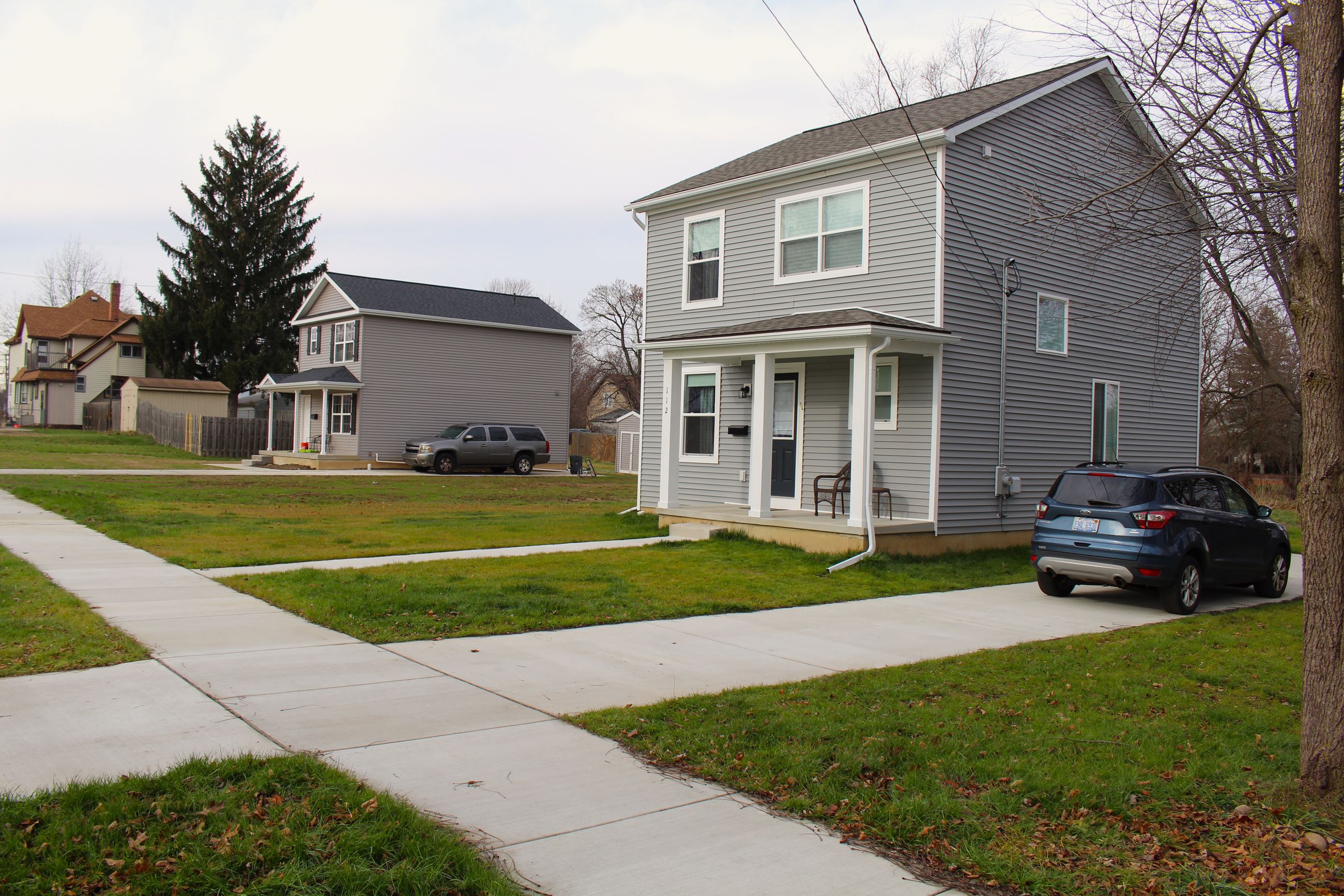Completed homes on E. Monroe Street, Paragon House Plan (left) and Norfolk Colonial Plan (right)