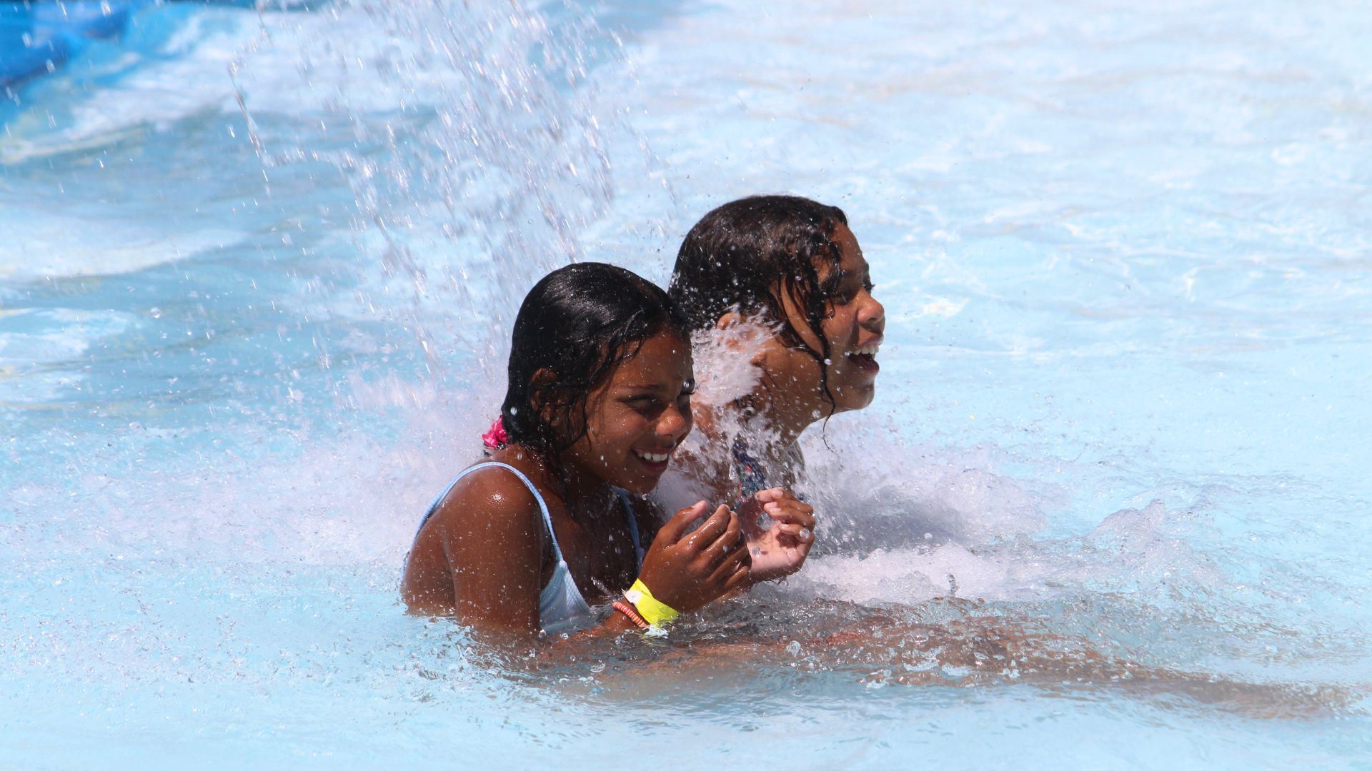 Two young girls enjoy a pool 