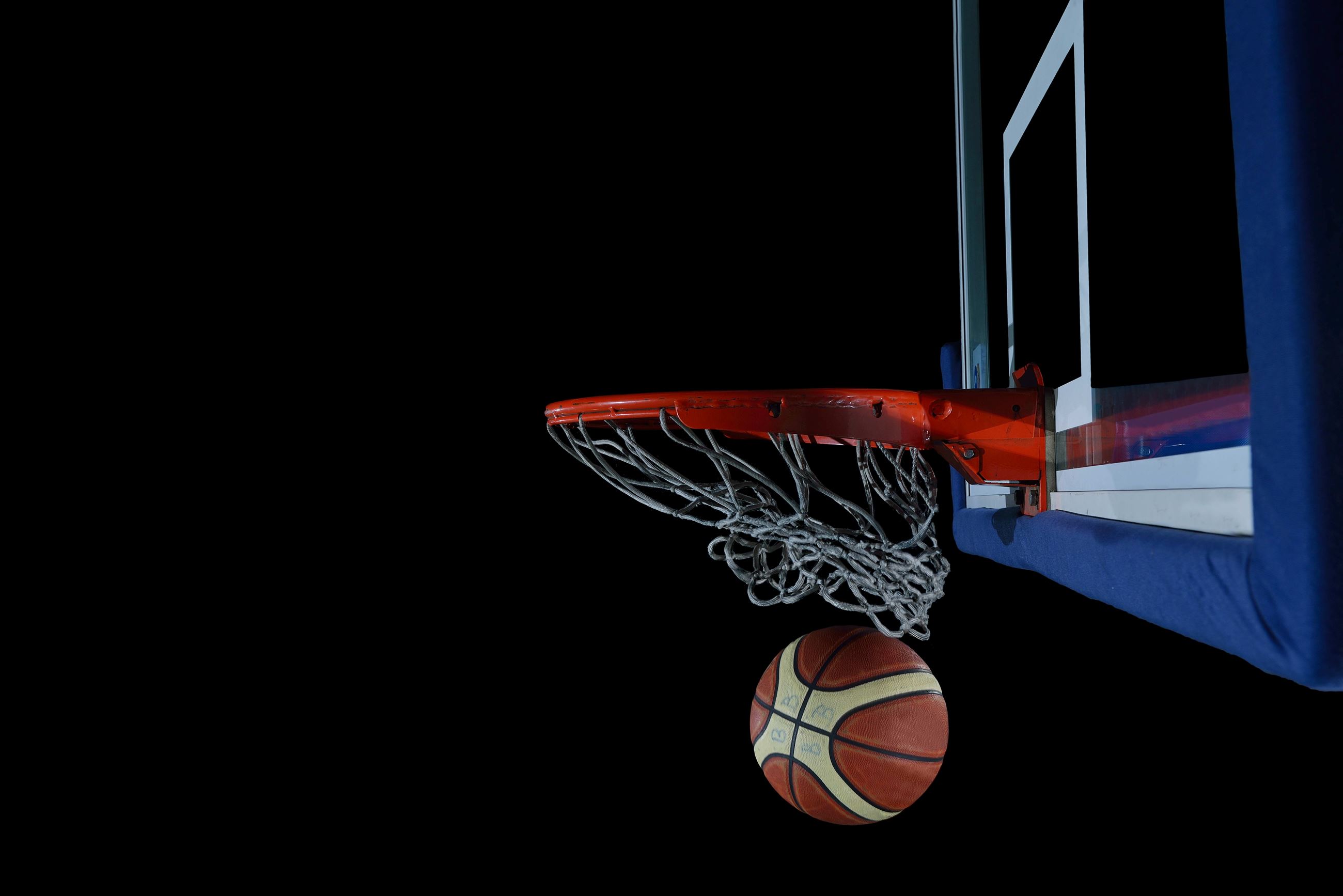 backboard-and-net-on-black-background-in-gym-indoor