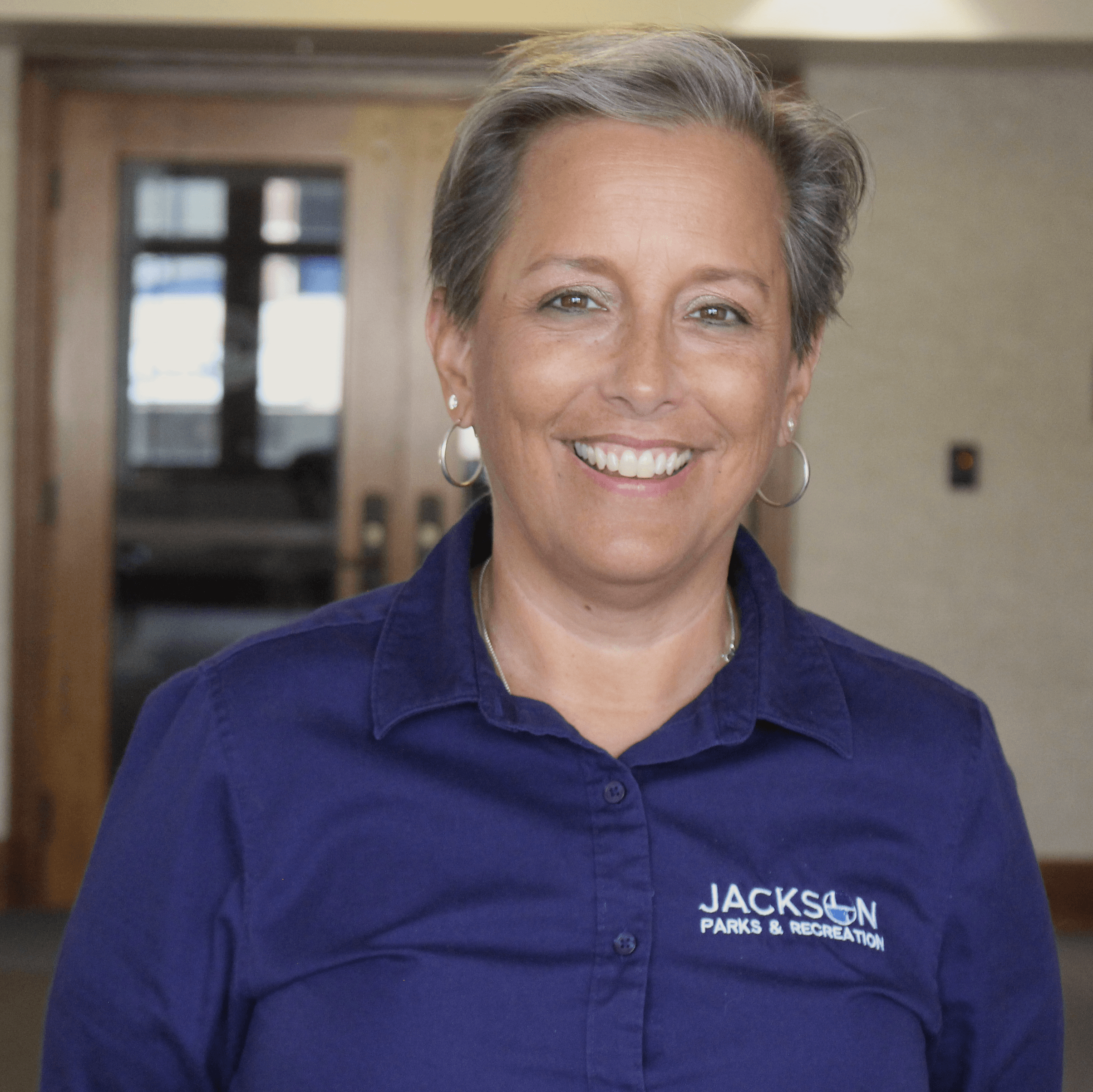 Woman wearing a blue shirt smiling 
