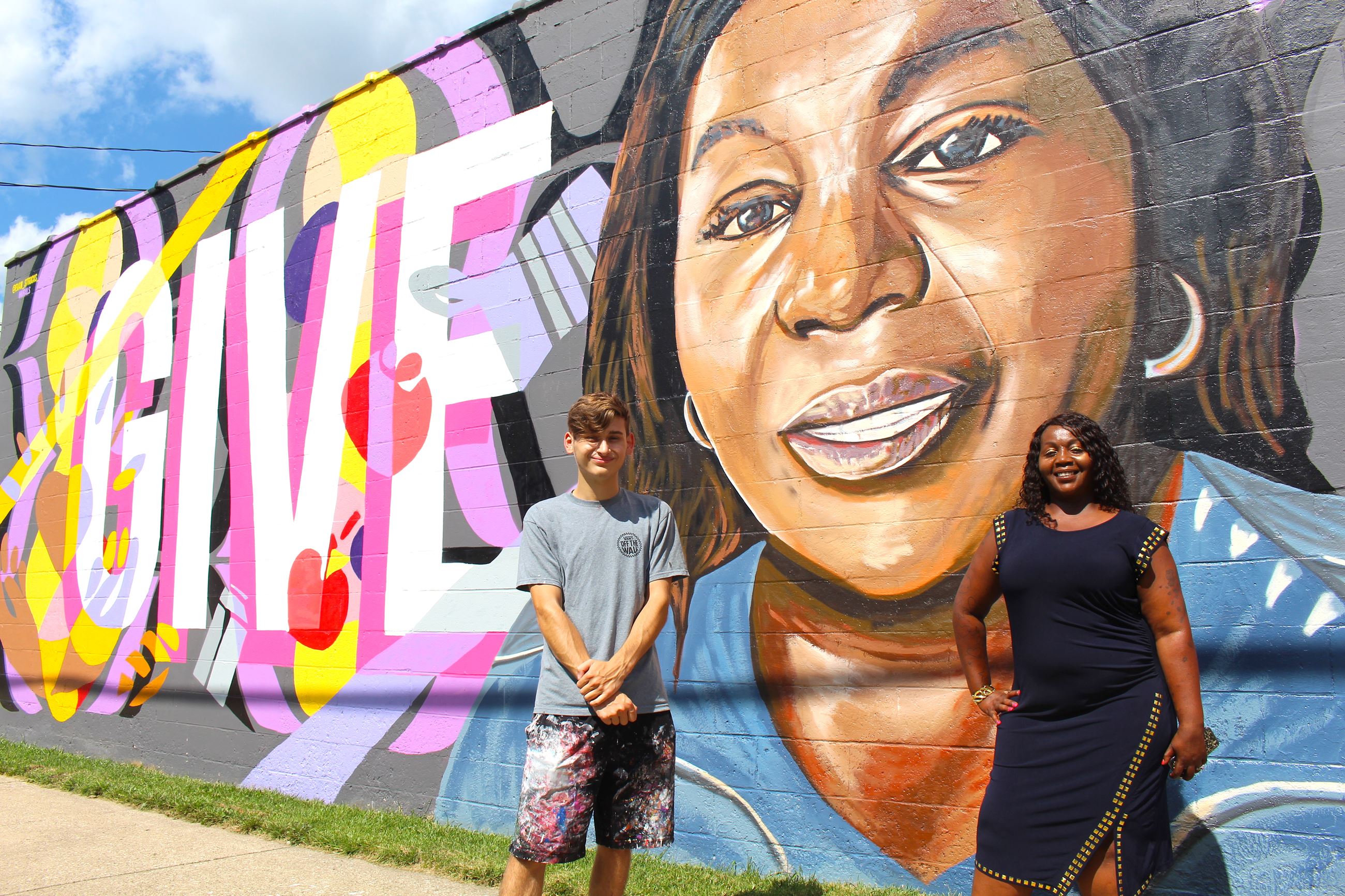 Evan Struck and Brenda Hughes pose in front of the mural on Clinton Road. 